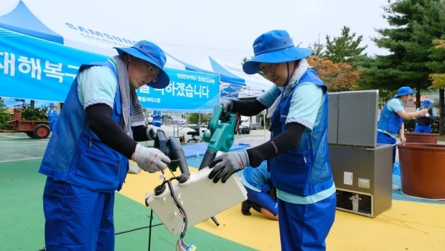 삼성전자서비스가 14일 고성군 거진청소년문화의집에 이동식 서비스센터를 설치하고 침수된 가전제품 세척, 점검, 수리 등 서비스를 제공하는 모습. ⓒ삼성전자서비