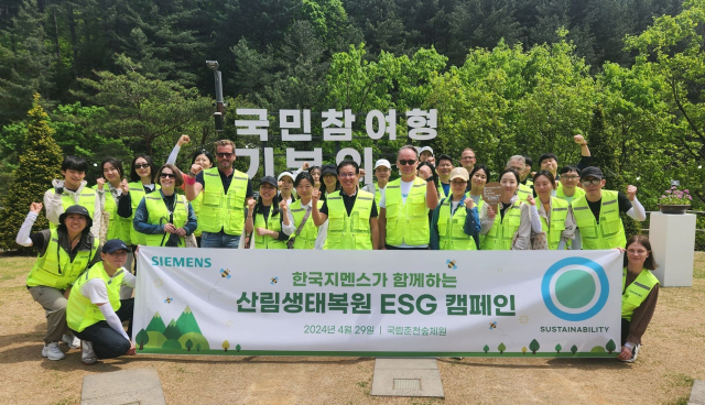 한국지멘스 임직원들이 29일 강원 춘천시 국립춘천숲체원에서 '산림생태복원 ESG 캠페인'을 진행한 뒤 기념사진을 촬영하고 있다. (앞줄 중앙 좌측)프랭크 짐머만 한국지멘스 수석부사장 및 최고재무관리자(CFO), (중앙)정하중 한국지멘스 대표이사·사장, (중앙 우측)티노 힐데브란트 한국지멘스 선임부사장 및 디지털 인더스트리 부문장. [ⓒ한국지멘스]